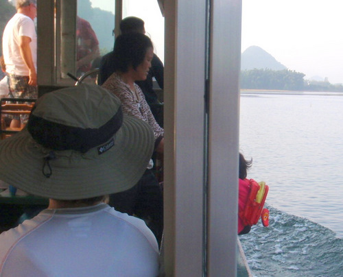 Granddaughter hanging out the boat, backward.